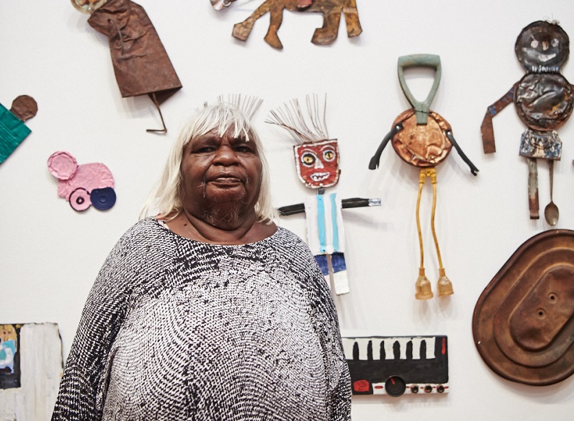 Artist Eunice Porter in front of the work she and other Warakurna artists created. Photography by Rebecca Mansell.
