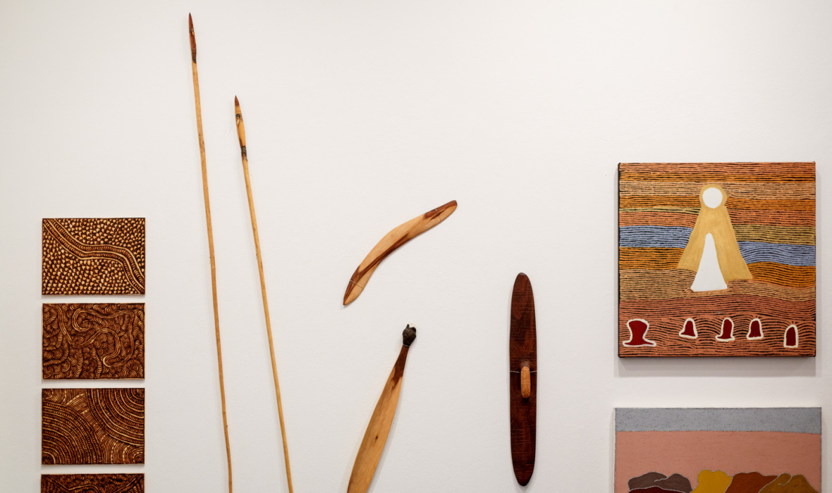 Works left to right: artists vary (Maruku Arts & Crafts), dimensions variable; Dorothy Ward (Warakurna & Kayili Artists), Wati Kutjarra, 2016, acrylic on canvas, 100 x 76cm. Photography by Jessica Wyld