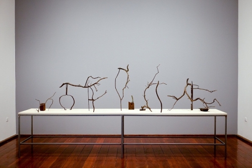 The Trail of Time, 2013, patinated bronze objects and table, dimensions variable