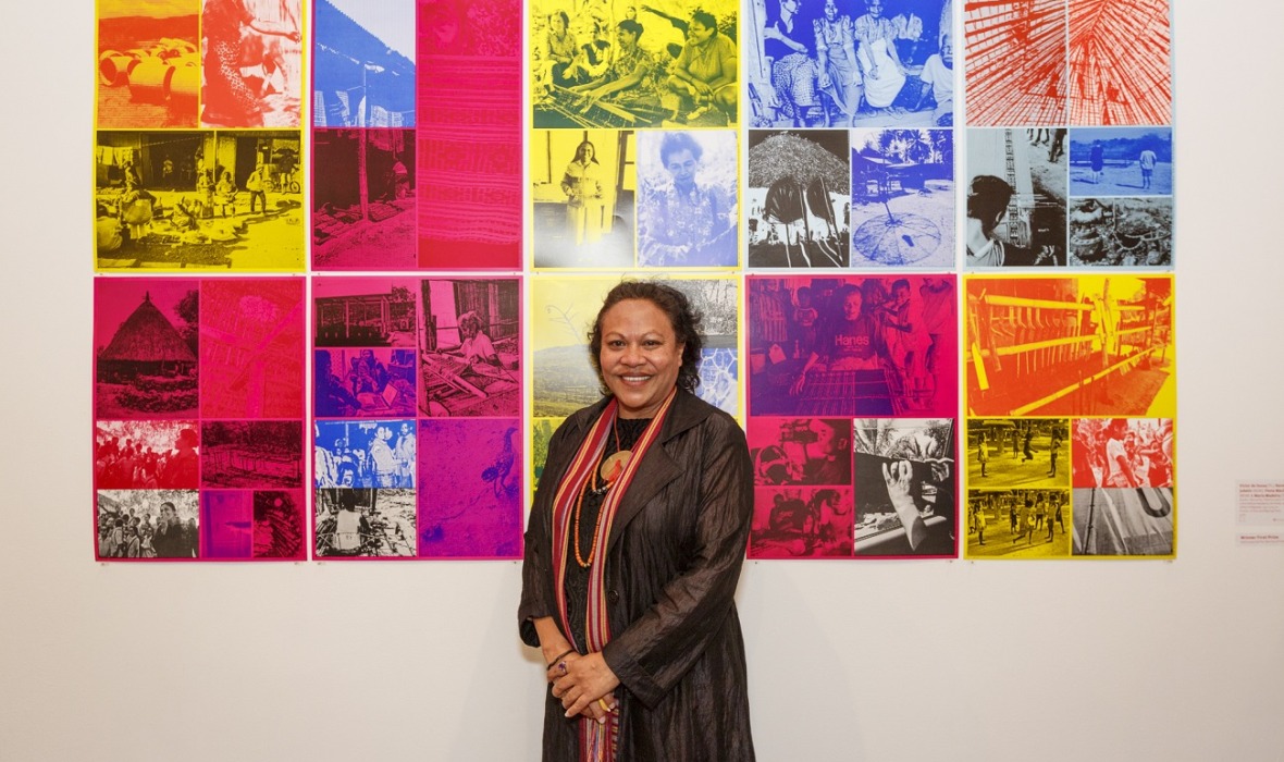 2015 FAC Print Award Winner Maria Madeira in front of work created with Victor de Sousa, Narelle Jubelin, Fiona Macdonald, Elastic / Borracha / Elastico (2012 Timor-Leste Mobile Residency Archive), 2014, offset lithograph, 135 x 275cm. Printed by Big Fag Press. Photography by Jessica Wyld