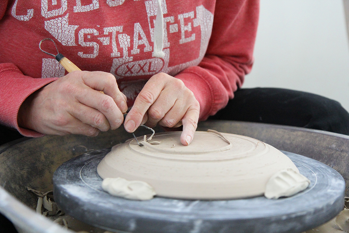Artist in Residence Stephanie Hammill wheel throwing in FAC's Ceramic Studio