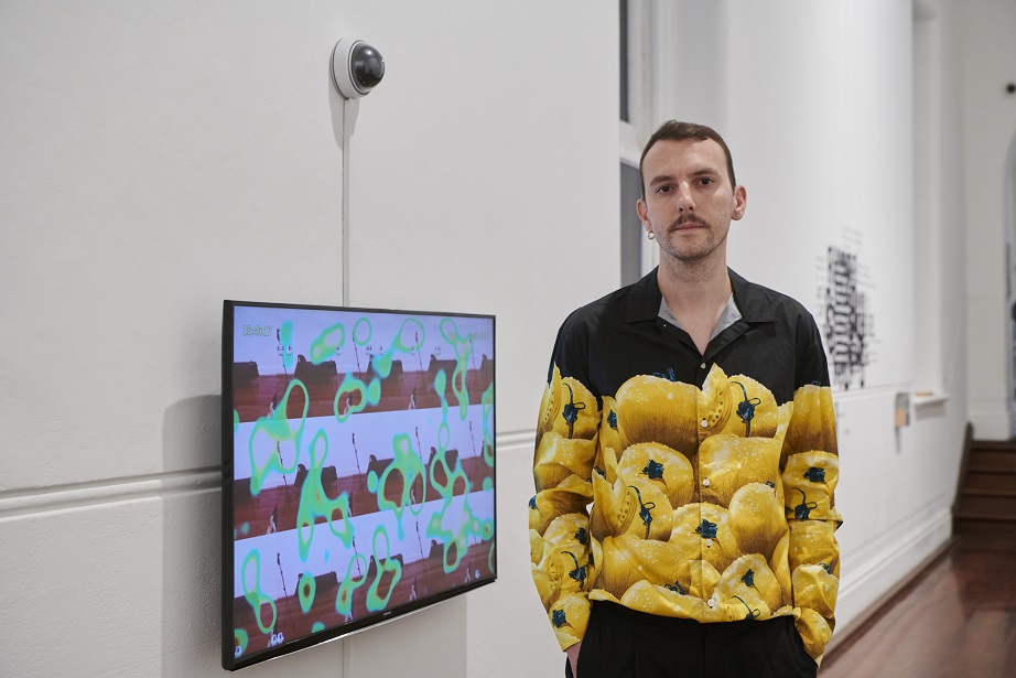 Dan Bourke with his work Hit Counter, 2020-21, single channel video and Raspberry Pi with camera, HTML, CSS, Javascript, Python, 20 min. Photography by Rebecca Mansell