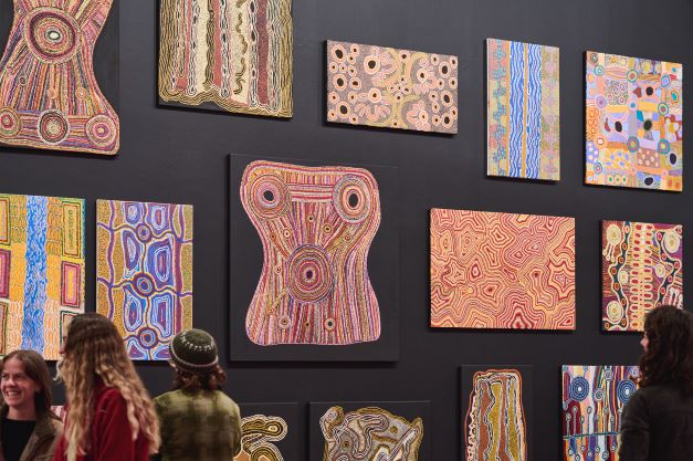 Various artworks by artists from Ninuku Arts, Papulankutja Artists and Warakurna artists at the opening of the Revealed Exhibition: New & Emerging WA Aboriginal Artists. Photography by Rebecca Mansell